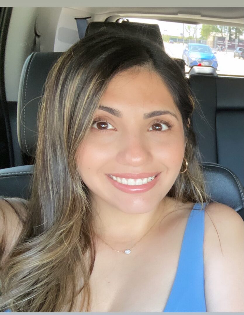 A woman sitting in the back of a car.